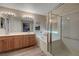 Well-lit bathroom features a double vanity, soaking tub, and separate glass-enclosed shower at 68 Vista Del Mar St, Henderson, NV 89012