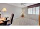 Neutral bedroom with carpet, ceiling fan, desk area, and window with shutters at 68 Vista Del Mar St, Henderson, NV 89012