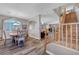 Open concept dining room featuring hardwood floors, a staircase, and lots of natural light at 68 Vista Del Mar St, Henderson, NV 89012