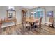 Elegant dining room featuring wood floors, detailed furniture, and ample natural light at 68 Vista Del Mar St, Henderson, NV 89012