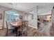 Dining room boasts wood floors, modern lighting, and a view of the living area and kitchen at 68 Vista Del Mar St, Henderson, NV 89012