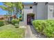Inviting front entrance featuring a red door, green bushes and a paved walkway at 68 Vista Del Mar St, Henderson, NV 89012