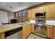 Well-lit kitchen features stainless steel appliances and wood cabinets with granite countertops at 68 Vista Del Mar St, Henderson, NV 89012