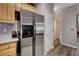 Kitchen area featuring stainless steel refrigerator, wood cabinets, and access to bathroom at 68 Vista Del Mar St, Henderson, NV 89012