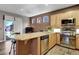 Kitchen with a breakfast bar, wood-look floors, stainless steel appliances, and plenty of countertop space at 68 Vista Del Mar St, Henderson, NV 89012