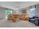 Large living room with a corner sofa, neutral carpet, and ample natural light at 68 Vista Del Mar St, Henderson, NV 89012