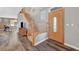 Open-concept living room features a beautiful staircase and a bright wooden door at 68 Vista Del Mar St, Henderson, NV 89012