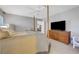 Cozy main bedroom with four poster bed, TV, and neutral décor at 68 Vista Del Mar St, Henderson, NV 89012