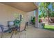 Cozy covered patio features a nice table and view of the landscaped backyard at 68 Vista Del Mar St, Henderson, NV 89012