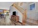View of a wooden staircase with carpeted stairs, light gray walls, and view of the kitchen area at 68 Vista Del Mar St, Henderson, NV 89012