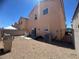 The backyard features a gravel landscape, patio, seating area, block wall, and BBQ grill at 6922 Majestic Palm Dr, Las Vegas, NV 89122