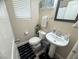 Half bathroom featuring a white toilet, sink, decor and mirror at 6922 Majestic Palm Dr, Las Vegas, NV 89122