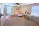 Bright and airy bedroom features neutral colors, a ceiling fan, carpet, and a functional desk area at 6922 Majestic Palm Dr, Las Vegas, NV 89122