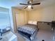 Neutral bedroom with a ceiling fan, a comfortable bed, a closet, and a desk for work or hobbies at 6922 Majestic Palm Dr, Las Vegas, NV 89122