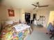 Cozy bedroom featuring carpeted floors, ceiling fan, closet, study desk, and natural lighting at 6922 Majestic Palm Dr, Las Vegas, NV 89122