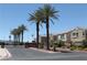 Gated community entrance featuring palm trees and manicured landscaping along the main street at 6922 Majestic Palm Dr, Las Vegas, NV 89122