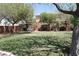 A green park area is shown with mature trees, a bench, and well-maintained landscaping at 6922 Majestic Palm Dr, Las Vegas, NV 89122