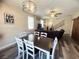 Open-concept dining room featuring a dining table with modern flooring, a chandelier and an open floor plan at 6922 Majestic Palm Dr, Las Vegas, NV 89122