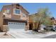 Charming two-story home showcasing a well-maintained front yard, driveway and attached two car garage at 6922 Majestic Palm Dr, Las Vegas, NV 89122