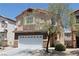 Charming two-story home showcasing a well-maintained front yard, walkway and attached two car garage at 6922 Majestic Palm Dr, Las Vegas, NV 89122