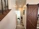 Hallway featuring a decorative wood door, stairs and view to the bathroom at 6922 Majestic Palm Dr, Las Vegas, NV 89122