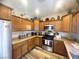 Traditional kitchen featuring wooden cabinets, stainless steel appliances, and stylish countertops with decor at 6922 Majestic Palm Dr, Las Vegas, NV 89122