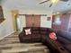 Comfortable living room featuring a plush sectional sofa, sliding barn doors, and modern flooring at 6922 Majestic Palm Dr, Las Vegas, NV 89122