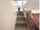 View of the staircase leading to the second floor with a stylish wrought iron handrail and wood steps at 6922 Majestic Palm Dr, Las Vegas, NV 89122