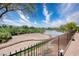 Scenic backyard view with desert landscaping and a pond, creating a tranquil outdoor space at 693 Hagens Aly, Mesquite, NV 89027