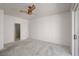 Minimalist bedroom featuring neutral carpet and walls, with a ceiling fan at 693 Hagens Aly, Mesquite, NV 89027