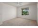 Bedroom with a ceiling fan and view of backyard through window at 693 Hagens Aly, Mesquite, NV 89027