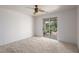 Clean bedroom with carpet, ceiling fan, and sliding door to the backyard at 693 Hagens Aly, Mesquite, NV 89027