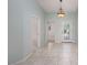 Hallway featuring tile flooring, light fixtures and entry to other rooms in home at 693 Hagens Aly, Mesquite, NV 89027