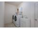 Bright laundry room with washer, dryer, utility sink, and ample cabinet space for storage at 693 Hagens Aly, Mesquite, NV 89027