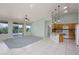Bright, open living space with tile floors, ceiling fan, and kitchen bar area at 693 Hagens Aly, Mesquite, NV 89027