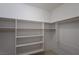 An organized walk-in closet with multiple shelves and clothing racks for ample storage space at 693 Hagens Aly, Mesquite, NV 89027
