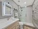 Modern bathroom with walk-in glass shower, sleek fixtures, and contemporary gray tile at 7952 Lonette Ave, Las Vegas, NV 89147
