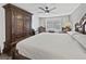 Bedroom with a large armoire, ceiling fan, and natural light from the window at 7952 Lonette Ave, Las Vegas, NV 89147