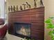 A stylish wood-trimmed fireplace with detailed craftsmanship and a collection of artful figurines at 7952 Lonette Ave, Las Vegas, NV 89147