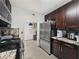 Kitchen showcasing stainless steel refrigerator, tile flooring, and pantry at 7952 Lonette Ave, Las Vegas, NV 89147
