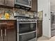Modern kitchen showcasing stainless steel double oven and wooden cabinets at 7952 Lonette Ave, Las Vegas, NV 89147