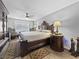 Well-lit bedroom featuring a dark wood bedframe, ceiling fan, and coordinating furniture at 7952 Lonette Ave, Las Vegas, NV 89147