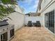 Cozy outdoor patio area with tile flooring, stainless steel barbecue, and a seating area for relaxation and entertaining at 7952 Lonette Ave, Las Vegas, NV 89147