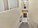Well-lit staircase with wood steps and white railing offers access to the upper and lower levels of the home at 7952 Lonette Ave, Las Vegas, NV 89147