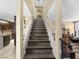 Elegant staircase connecting multiple levels with wood steps and white railing, leading to additional living spaces at 7952 Lonette Ave, Las Vegas, NV 89147