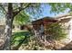Cozy backyard patio with a wooden pergola and lush greenery offering a relaxing outdoor space at 8213 Cabin Springs Ave, Las Vegas, NV 89131