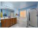 Bathroom features separate shower and bathtub, dual sinks, and a window at 8213 Cabin Springs Ave, Las Vegas, NV 89131