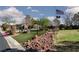 Scenic community park with walking paths, well-manicured landscaping, and an American flag at 8213 Cabin Springs Ave, Las Vegas, NV 89131