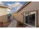 Exterior view of the home featuring a landscaped walkway, sliding glass doors and desert landscaping at 8213 Cabin Springs Ave, Las Vegas, NV 89131