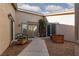Welcoming front courtyard with decorative planters, seating, and double-door entry at 8213 Cabin Springs Ave, Las Vegas, NV 89131